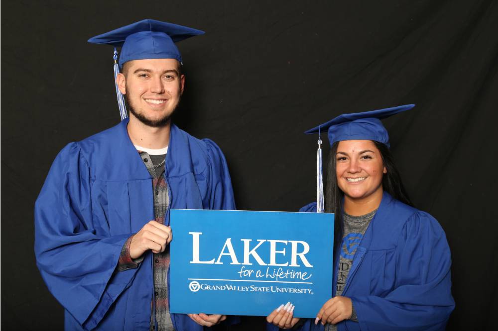 two people hold laker sign